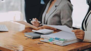 Business team meeting present, investor colleagues consultation and conference new strategy plan business and market growth on financial document graph report, Meeting and Talking. video