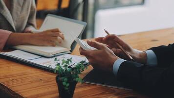 Business team meeting present, investor colleagues consultation and conference new strategy plan business and market growth on financial document graph report, Meeting and Talking. video