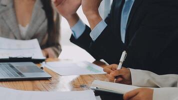 Business team meeting present, investor colleagues consultation and conference new strategy plan business and market growth on financial document graph report, Meeting and Talking. video
