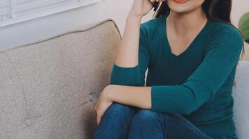 Smiling businesswoman using phone in office. Small business entrepreneur looking at her mobile phone and smiling. video