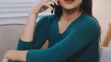 souriant femme d'affaires en utilisant téléphone dans bureau. petit affaires entrepreneur à la recherche à sa mobile téléphone et souriant. video