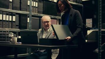 Federal investigators examining forensic evidence and autopsy reports to connect the dots and find a culprit. Team of detective and private agent working on solving criminal activity. Camera B. video