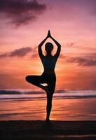AI generated Silhouette of young woman practicing yoga on the beach at sunset. ai generative photo