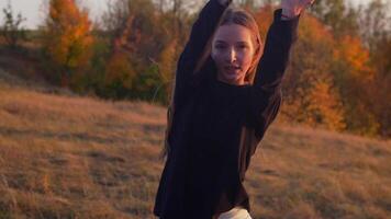 A girl dances in the evening in nature video