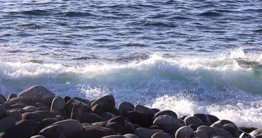 ein schleppend Bewegung von Welle beim das Küste sonnig Tag Tele Schuss video