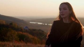 A girl dancing against the background of a river. slow motion video