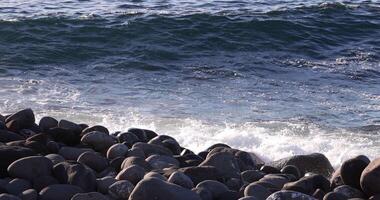 A wave at the coast sunny day telephoto shot video