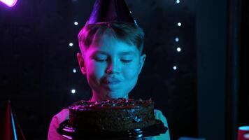 A boy bites a chocolate birthday cake video