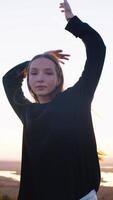 A girl with long hair is dancing against the sky. video