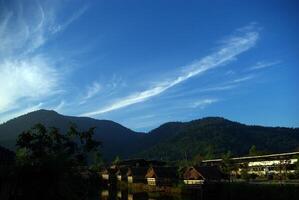 In the morning light small huts beside the lake and the mountain view photo