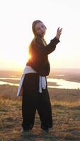 A girl dances a modern dance against the background of a river video