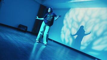 Person presenting with a brain graphic projection in a dimly lit room, depicting a concept of education or idea sharing. video