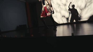 Dancer on stage with dramatic shadow in the background. video