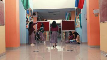 Students interacting in a colorful school hallway with flags and posters on the walls. video