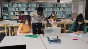 Young diverse people studying in library - School education concept video