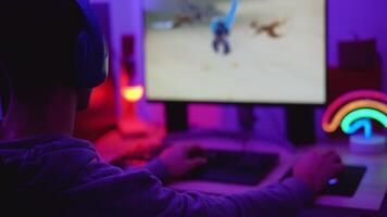 Young gamers having fun playing online video games with computer at home - Gaming entertainment and technology concept