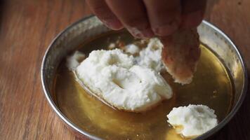 butter cream and honey in a bowl on table . video