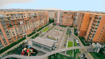 View from above of the courtyard of new buildings, a modern children's playground, landscaping near each house, recreation areas, a fountain. Modern view of the courtyard of a new residential complex. video