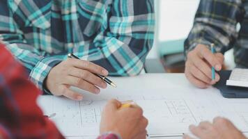 Architector and engineers with draft plan of building and tablet talking on constructing site. Construction manager and engineer working on building site. video