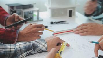 Architector and engineers with draft plan of building and tablet talking on constructing site. Construction manager and engineer working on building site. video