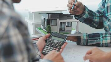 Architector and engineers with draft plan of building and tablet talking on constructing site. Construction manager and engineer working on building site. video