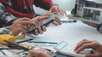 Architector and engineers with draft plan of building and tablet talking on constructing site. Construction manager and engineer working on building site. video