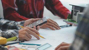 arquitecto y ingenieros con sequía plan de edificio y tableta hablando en construyendo sitio. construcción gerente y ingeniero trabajando en edificio sitio. video