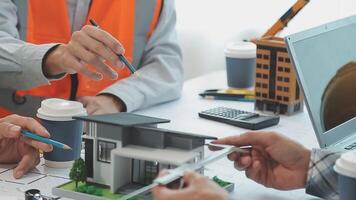 Architector and engineers with draft plan of building and tablet talking on constructing site. Construction manager and engineer working on building site. video