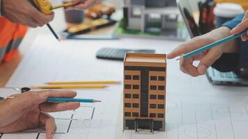 Architector and engineers with draft plan of building and tablet talking on constructing site. Construction manager and engineer working on building site. video