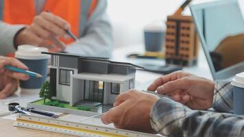 Architector and engineers with draft plan of building and tablet talking on constructing site. Construction manager and engineer working on building site. video