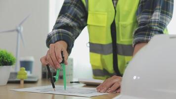 Architector and engineers with draft plan of building and tablet talking on constructing site. Construction manager and engineer working on building site. video