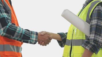 Architector and engineers with draft plan of building and tablet talking on constructing site. Construction manager and engineer working on building site. video