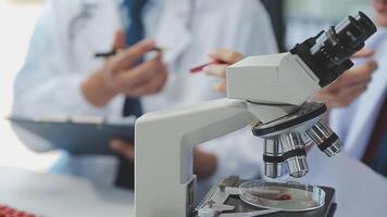 asian scientist team meeting and writing analysis results in the laboratory video