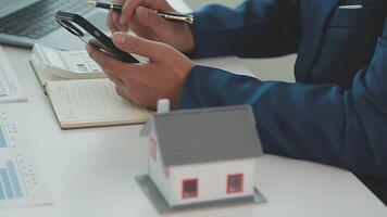 agente di intermediazione immobiliare in fase di analisi e prendere la decisione di un mutuo per la casa al cliente di firmare documenti contrattuali per l'acquisto di immobili, i dipendenti della banca raccomandano l'approvazione del mutuo ipotecario. video