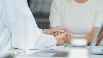 Emotional comfort stored in fingerprints. Shot of an unrecognizable doctor holding hands with her patient during a consultation. video