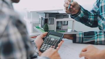 Architector and engineers with draft plan of building and tablet talking on constructing site. Construction manager and engineer working on building site. video