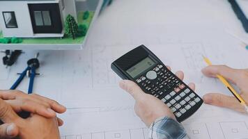 Architector and engineers with draft plan of building and tablet talking on constructing site. Construction manager and engineer working on building site. video