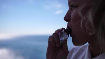 femme mer Chocolat. blond affaires femme jouit mer, se livrer dans Chocolat. travail avec ordinateur portable, numérique nomade mode de vie. détendu et souriant, elle trouve réconfort de travail stress parmi serein bleu mer video