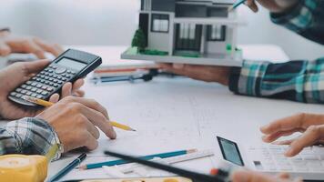 Architector and engineers with draft plan of building and tablet talking on constructing site. Construction manager and engineer working on building site. video