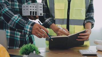 Architector and engineers with draft plan of building and tablet talking on constructing site. Construction manager and engineer working on building site. video