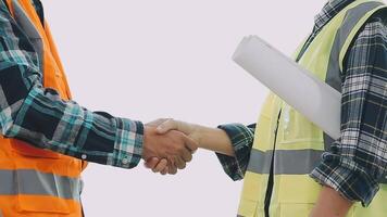 Architector and engineers with draft plan of building and tablet talking on constructing site. Construction manager and engineer working on building site. video