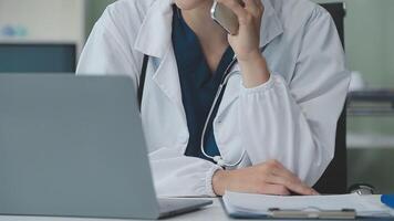 Doctor and patient discussing something while sitting at the table . Medicine and health care concept. Doctor and patient video