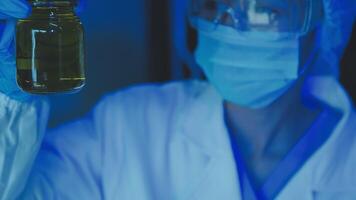 Young scientists conducting research investigations in a medical laboratory, a researcher in the foreground is using a microscope video