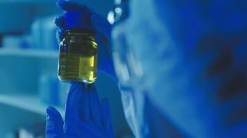 Young scientists conducting research investigations in a medical laboratory, a researcher in the foreground is using a microscope video