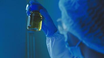 Young scientists conducting research investigations in a medical laboratory, a researcher in the foreground is using a microscope video