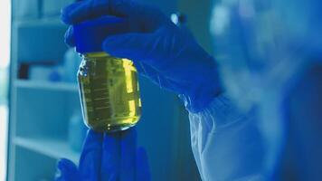 Young scientists conducting research investigations in a medical laboratory, a researcher in the foreground is using a microscope video