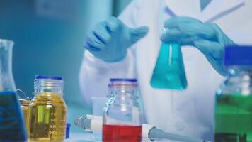 Young scientists conducting research investigations in a medical laboratory, a researcher in the foreground is using a microscope video