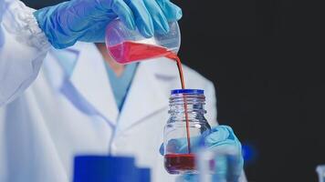 Young scientists conducting research investigations in a medical laboratory, a researcher in the foreground is using a microscope video