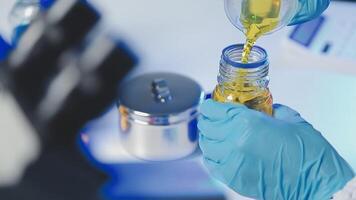 Young scientists conducting research investigations in a medical laboratory, a researcher in the foreground is using a microscope video