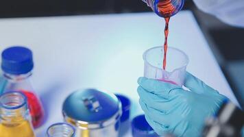 Young scientists conducting research investigations in a medical laboratory, a researcher in the foreground is using a microscope video